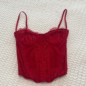 Out from under red lace corset top